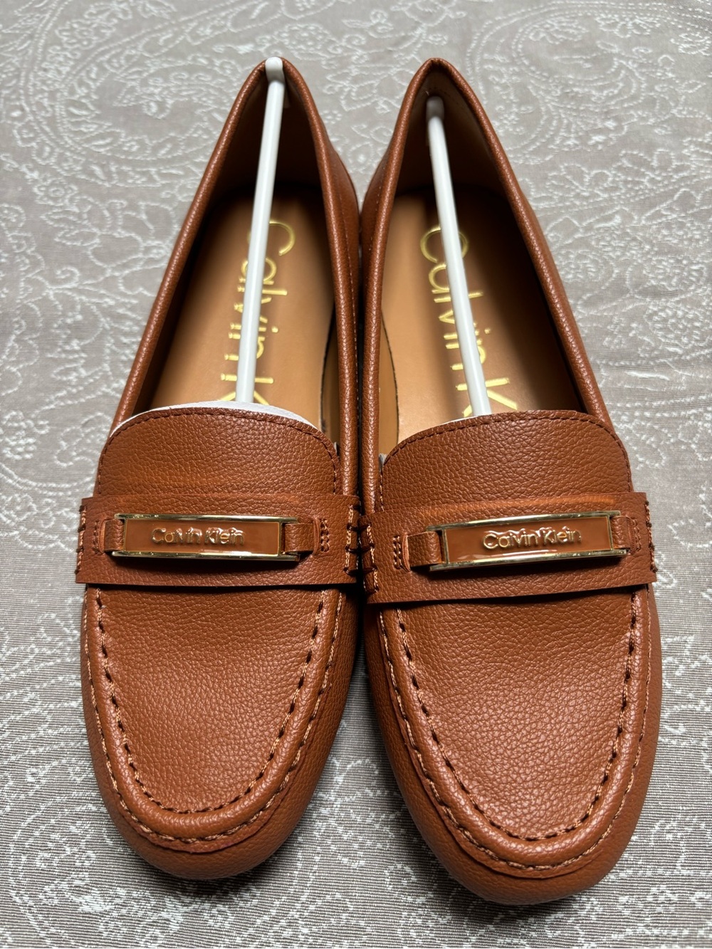 New without box Calvin Klein Cognac Leather Penny Loafers with Gold Plaque